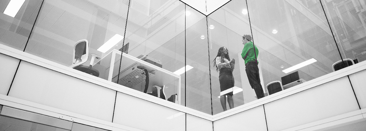 Decorative image: two people talking behind a window one floor up