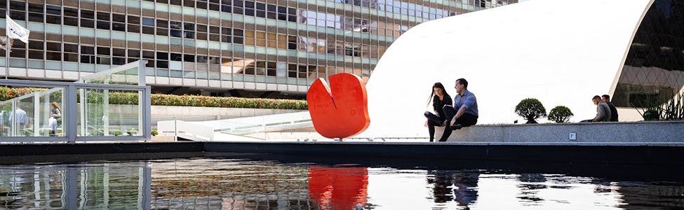 two people sitting by pond