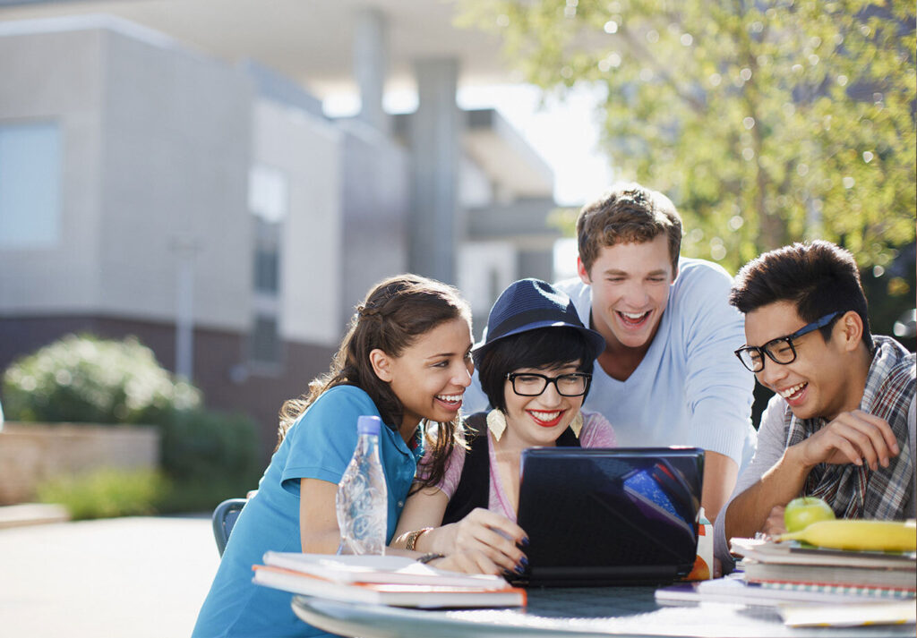 Students outside on laptop