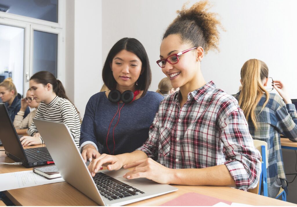 Female students on laptop in class