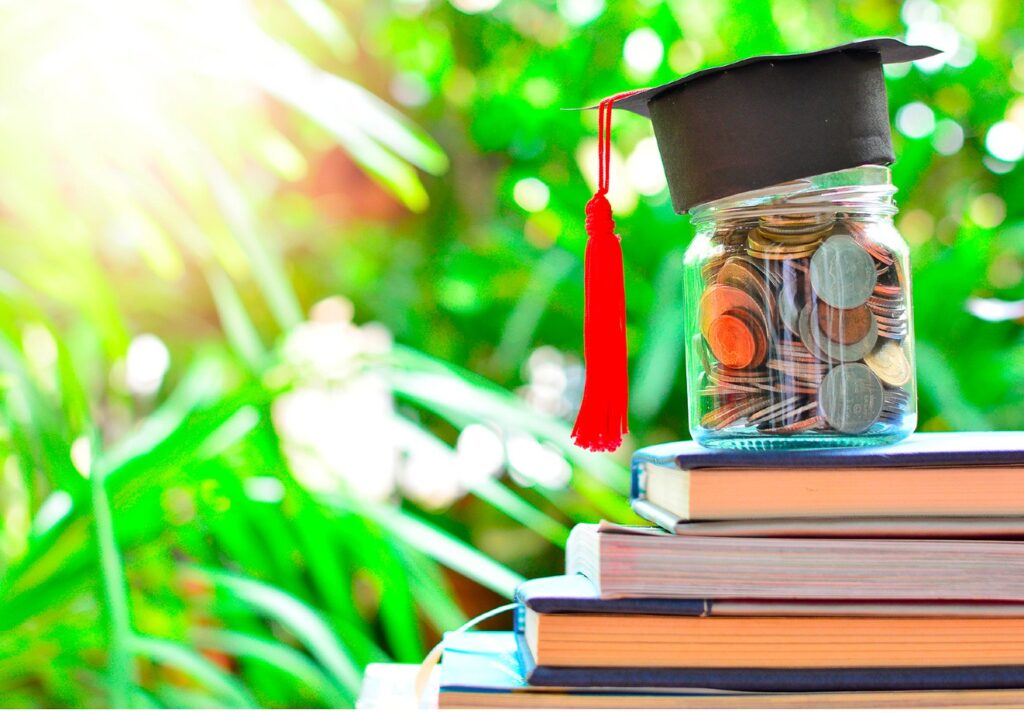 Jar of money stacked on books