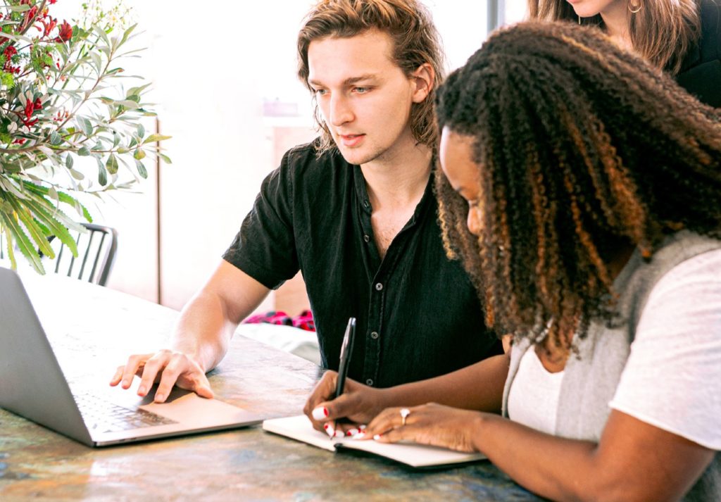 2 people in front of a laptop