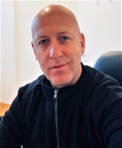 a man sitting down smiling