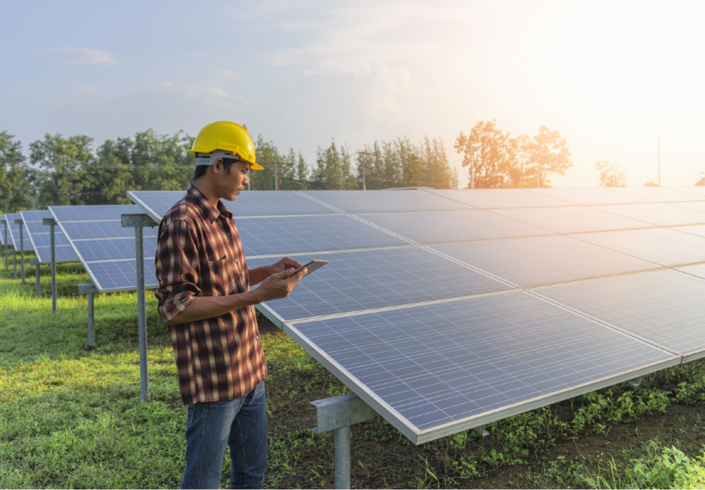 Man in front of solar panels