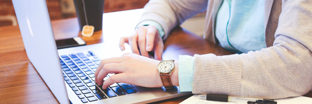 hands typing on keyboard